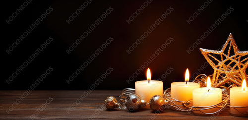 Merry Christmas and happy New Year. A warm dark golden brown wooden background with burning candles and a Christmas star. Elegant low-key shot with festive mood. Template for the congratulatory text.