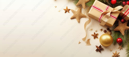 Christmas decoration composition on light gold background with beautiful Golden gift box with red ribbon, fir branches, stars, top view, copy space, banner format.