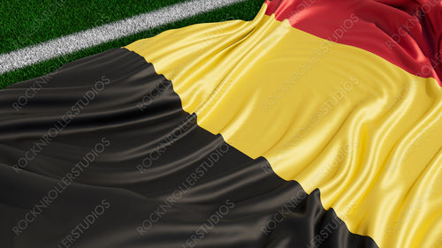 Flag of Belgium on a Sports field. Grass Pitch with a Belgian Flag. Euro 2020 Football Background.