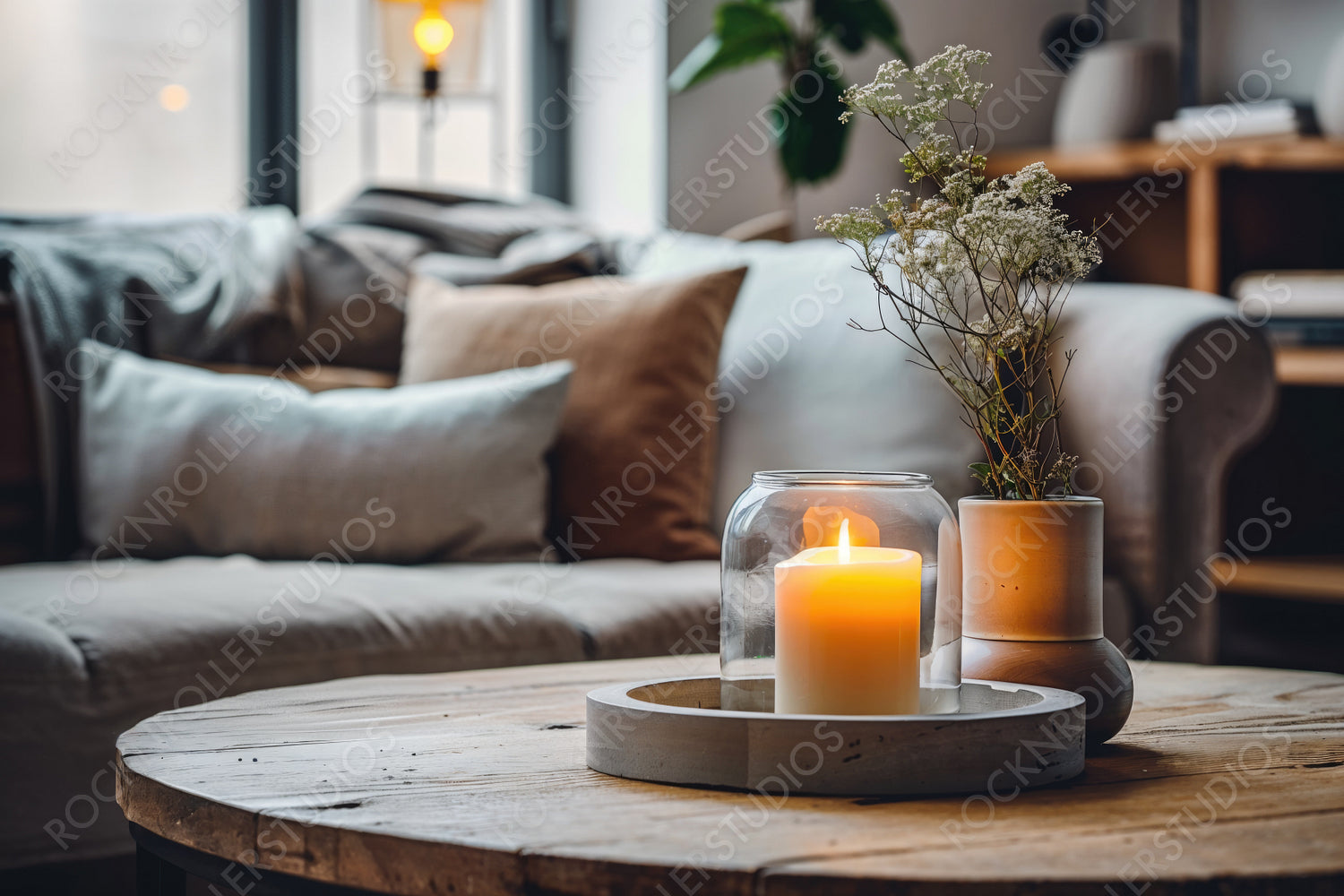 Cozy Living Room with Rustic Charm: Candlelit Coffee Table and Floral Touches