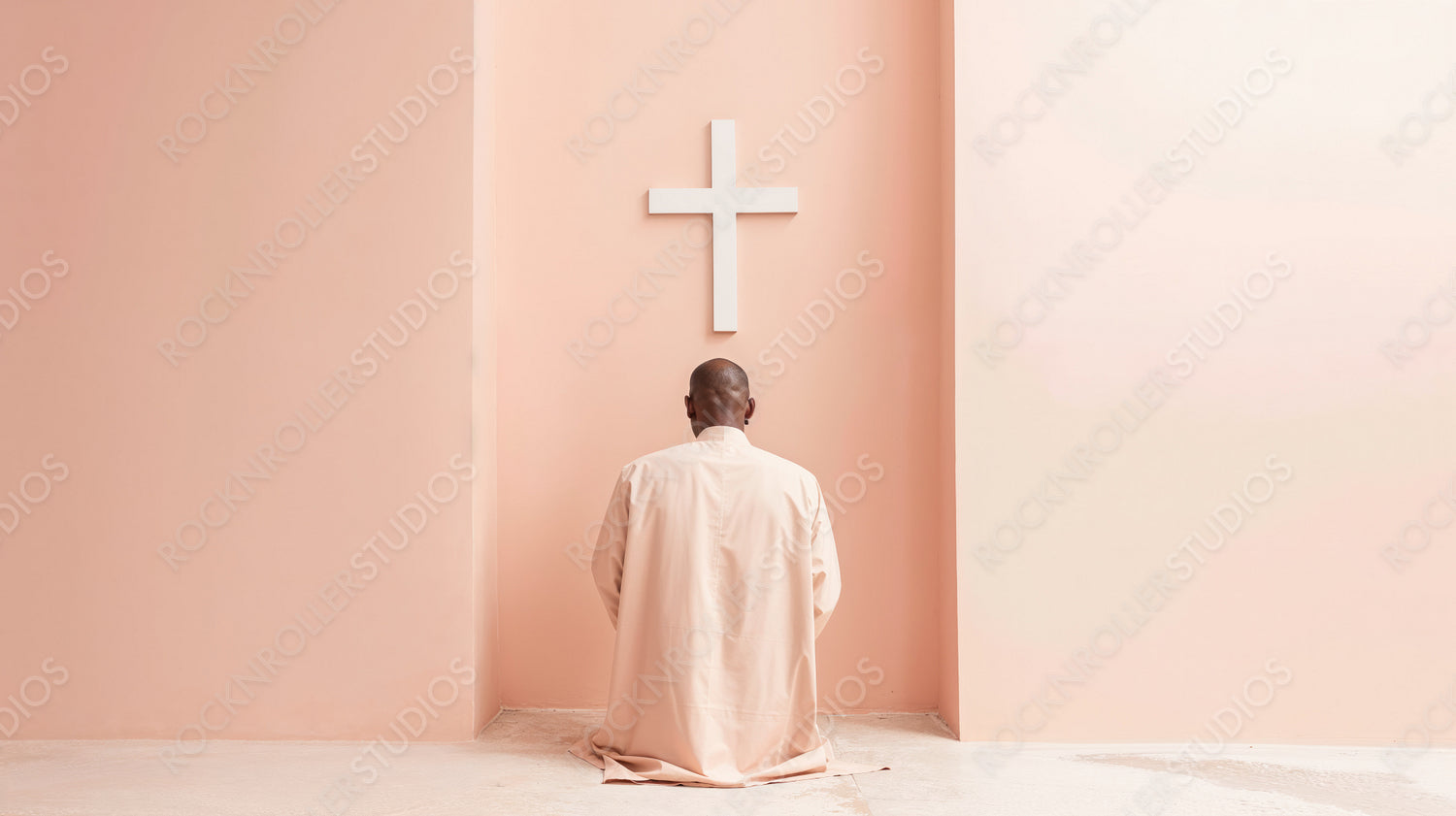 Man Praying in Serene Minimalist Space with Soft Pink Walls and Cross