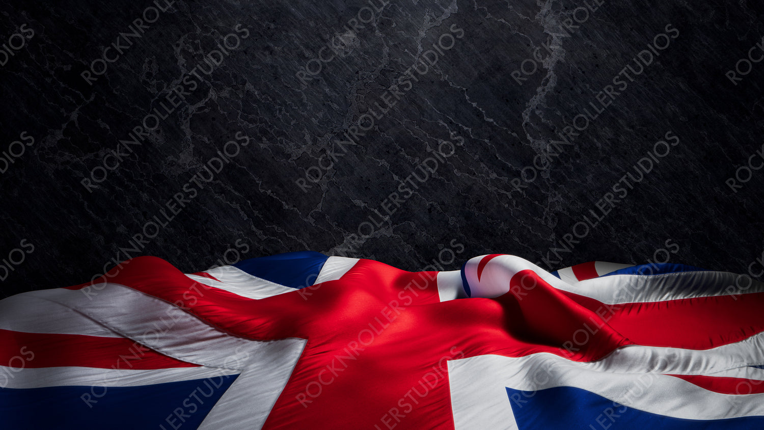 Dramatic Union Jack Flag Waves Against a Dark Textured Slate Background with copy-space