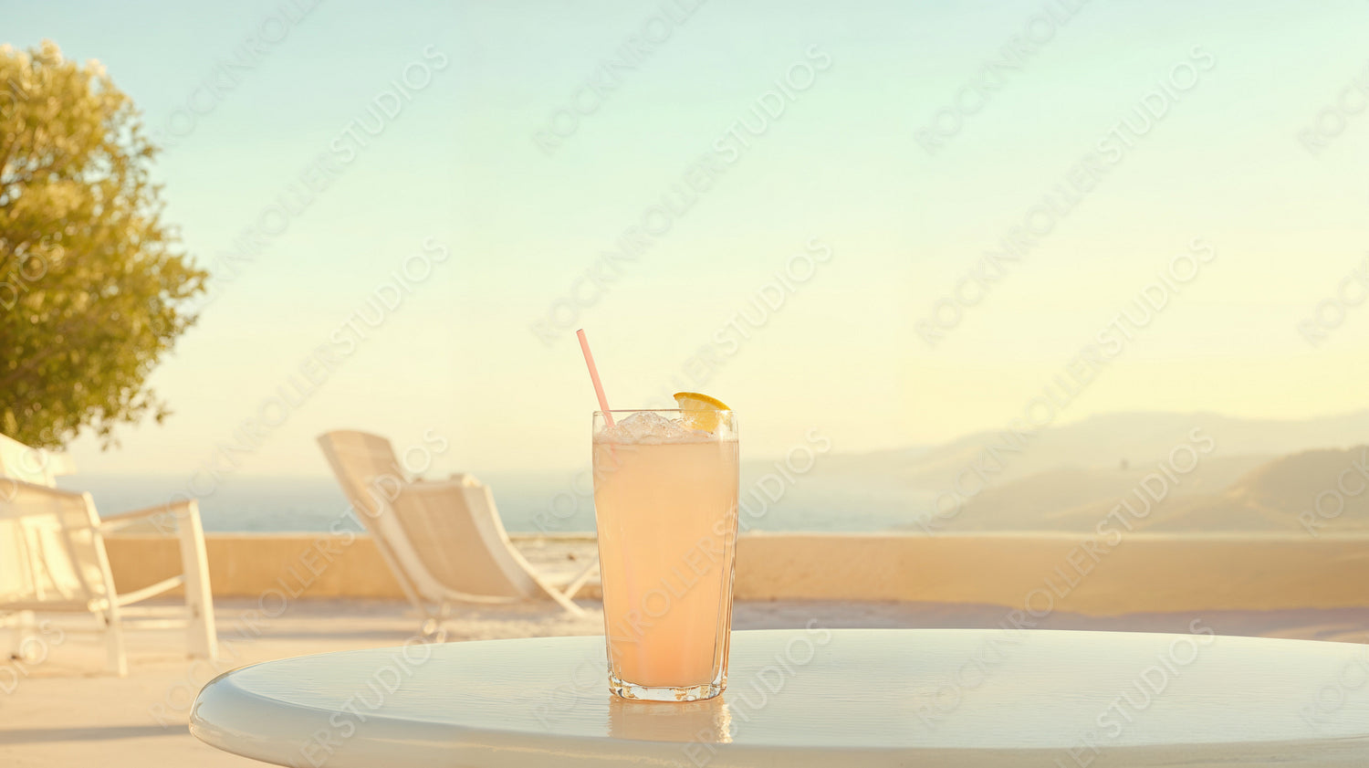 Sunset Sip: Luxurious Seaside Retreat with Refreshing Summer Beverage on a Serene Sandy Beach