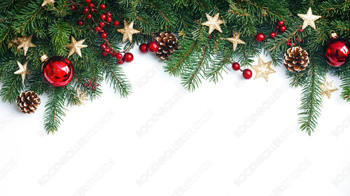 Christmas Pine Decorations with Red Ornaments and Gold Stars Against a White Background