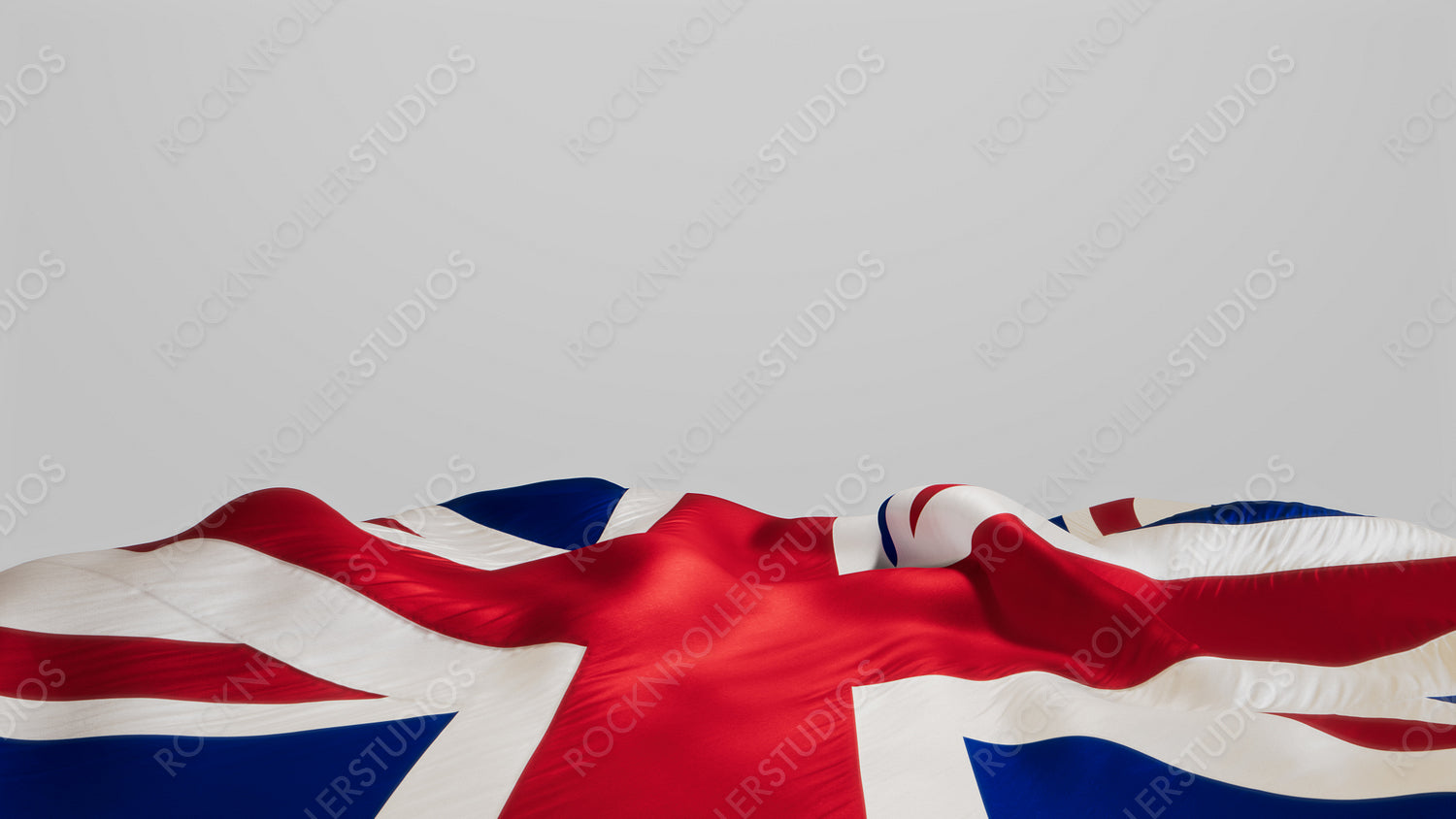 Vibrant Union Jack Flag Waving Proudly Against a Neutral Background with copy-space