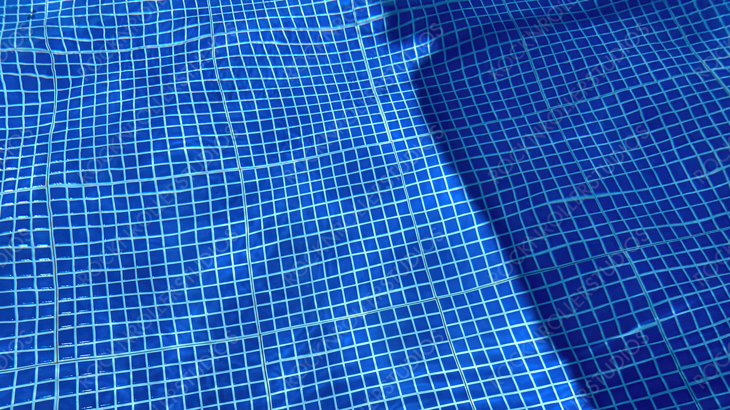 Detailed Blue Pool Tiles with Water Ripples, Sunlit Pool Surface