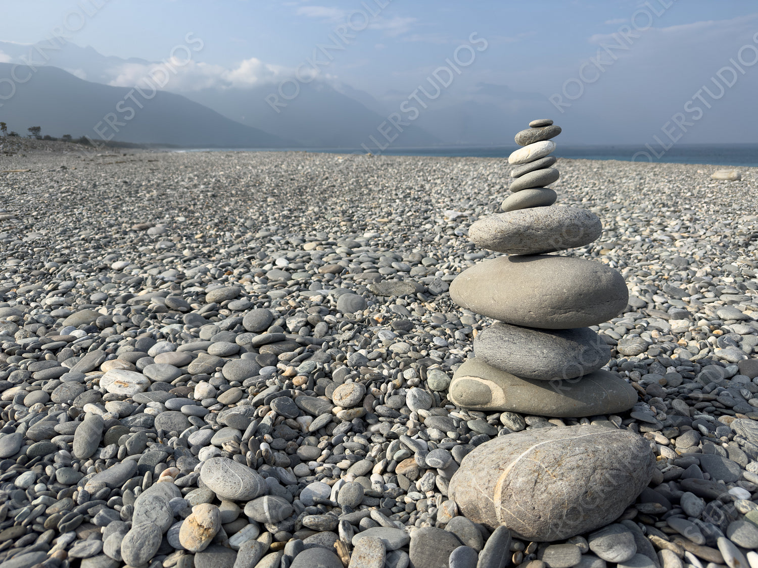 Stack of Smooth Stones on Pebble Beach, Tranquil Setting