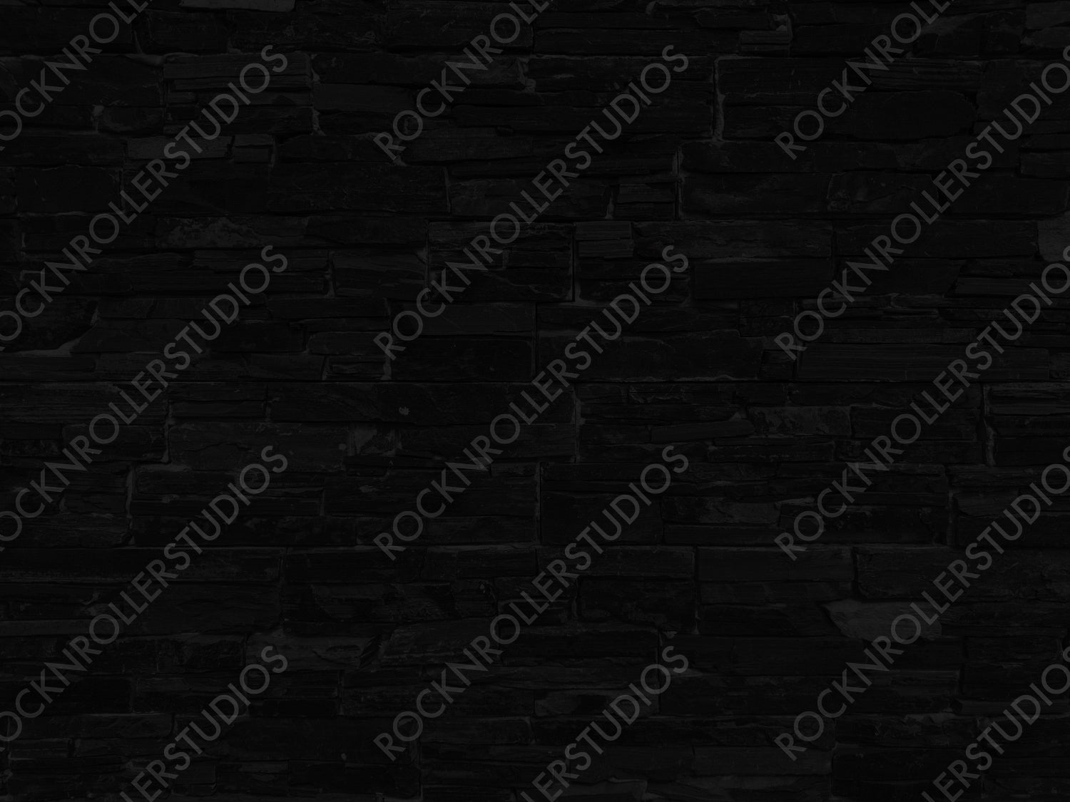 Mysterious Monochrome: Textured Black Stone Wall in Staggered Pattern