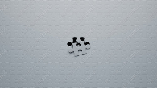 Striking Contrast: White Jigsaw Puzzle with One Missing Piece Revealing Black Pieces