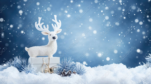 White Reindeer Figurine Standing in Snowy Landscape with Blue Snowflakes and Present