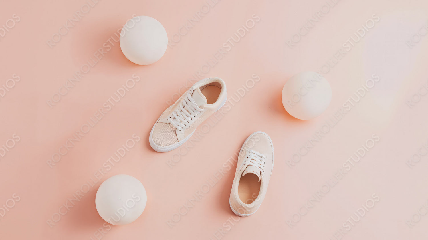 Active Lifestyle Concept with Sneakers and Balls in Pastel Pink Setting