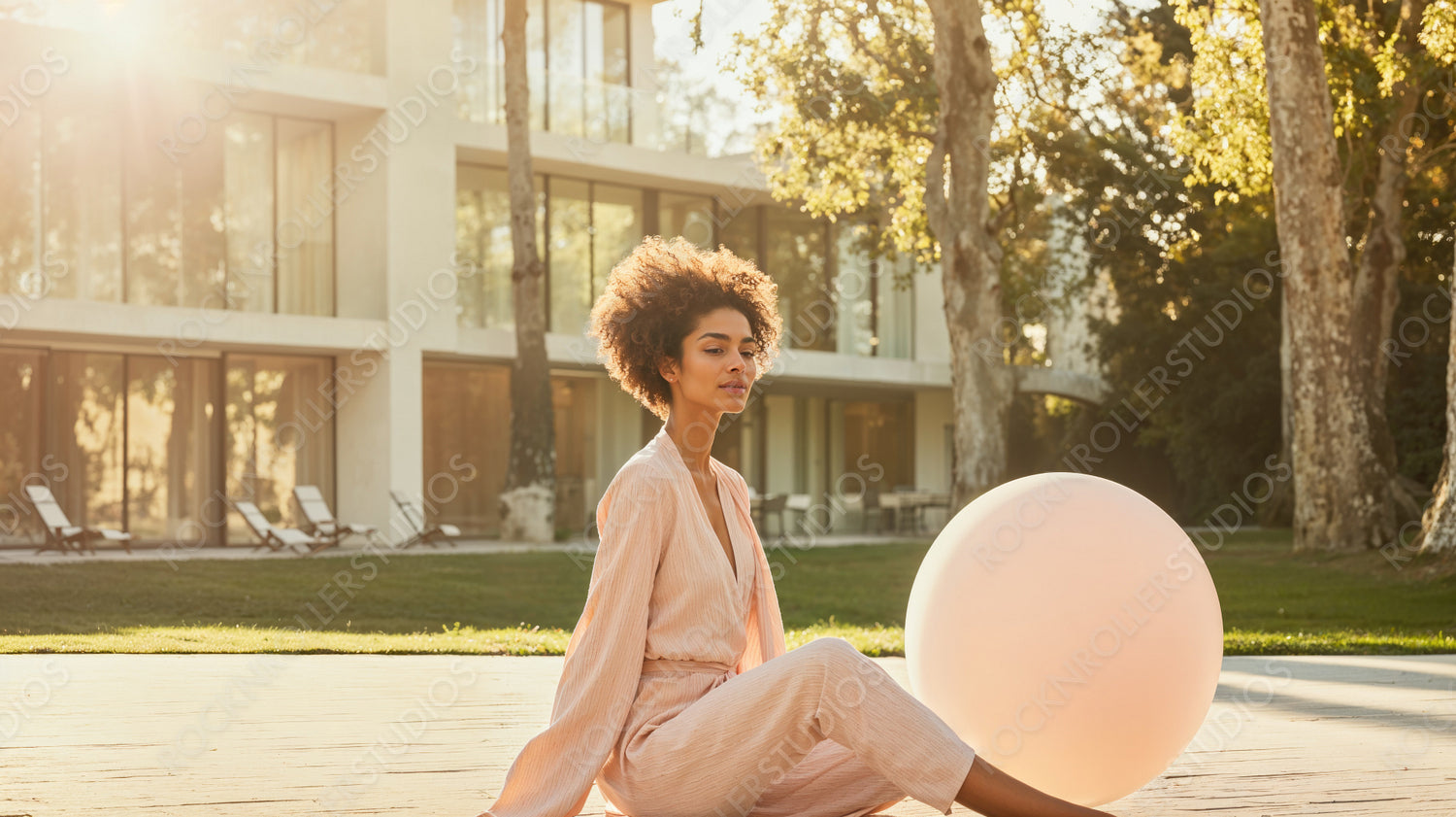 Sunset Serenity: Elegant Woman Meditating by Modern Luxury Home