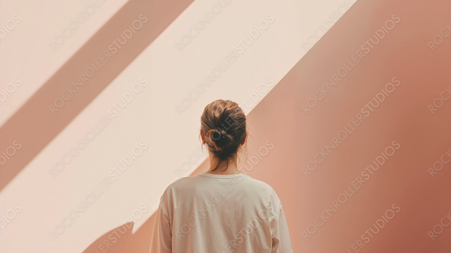 Back View of Woman Standing in Soft Sunlight