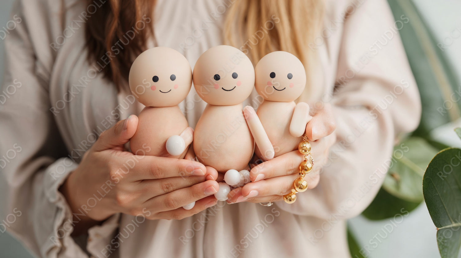 Family Concept with Three Cute Wooden Dolls in Hands