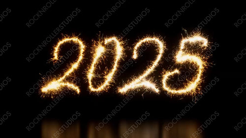 Gold Sparkler Firework Text with 2025 Caption on Black. Animated New Year Banner. Seamless Loop.