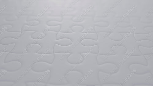 Perfect Fit: Close-Up of a White Jigsaw Puzzle Highlighting Unity and Detail