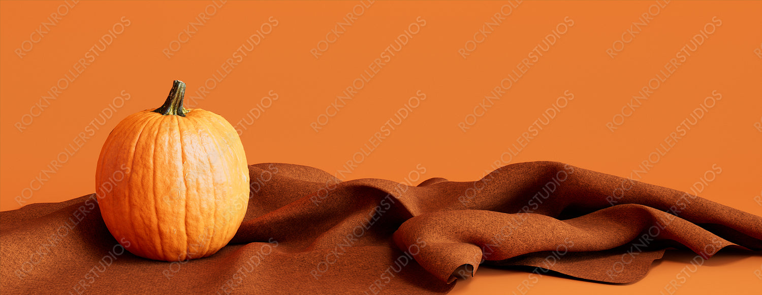 Pumpkin with Orange colored Blanket. Fall themed Banner with copy-space.