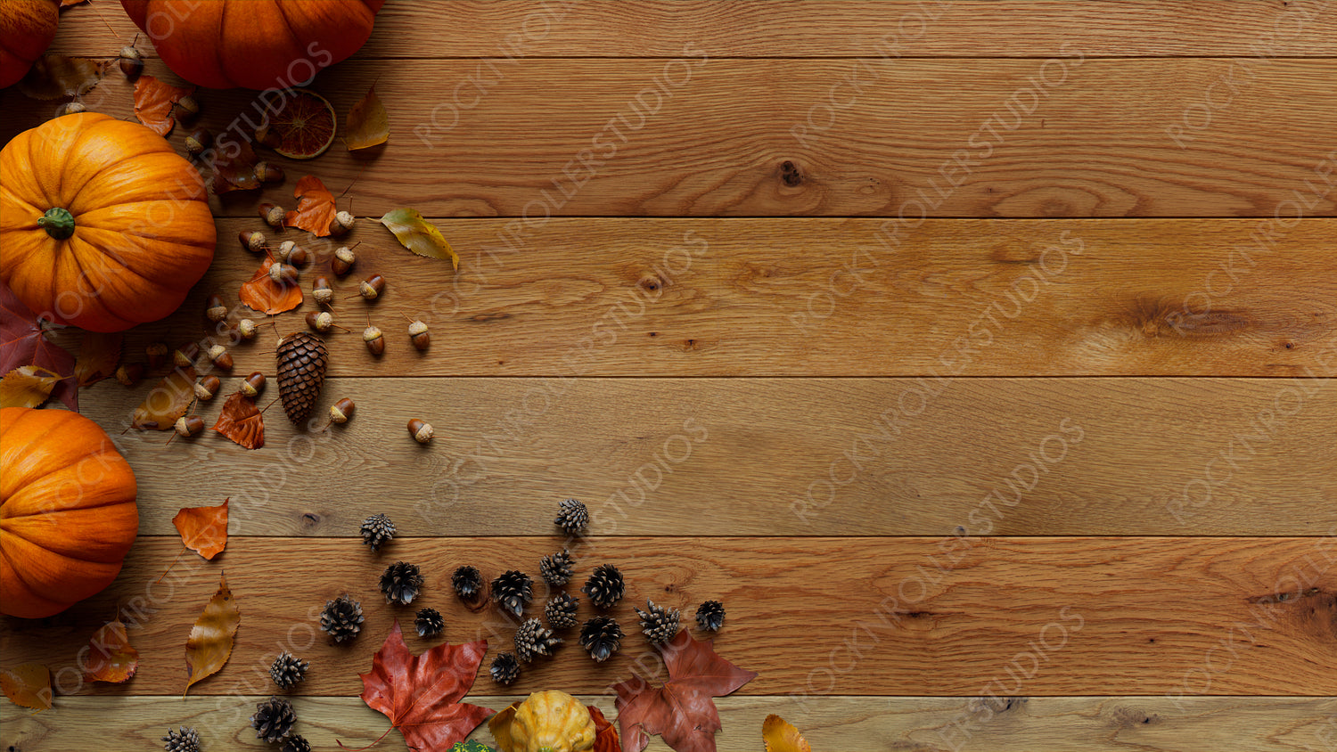Top down view of Natural wood Surface with leaves, Pumpkins and Acorns.