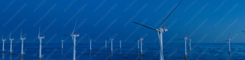Wind Power. Offshore Wind Turbines on a Clear Evening. Sustainable Electricity Concept.