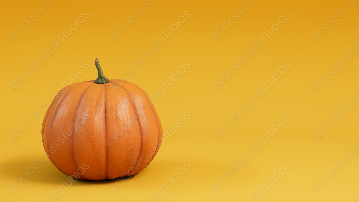 Pumpkin on a Mustard Yellow colored background. Fall themed Image with copy-space.